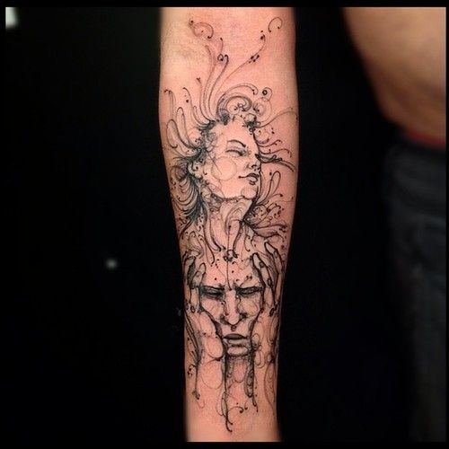 Small black ink forearm tattoo of woman and man faces