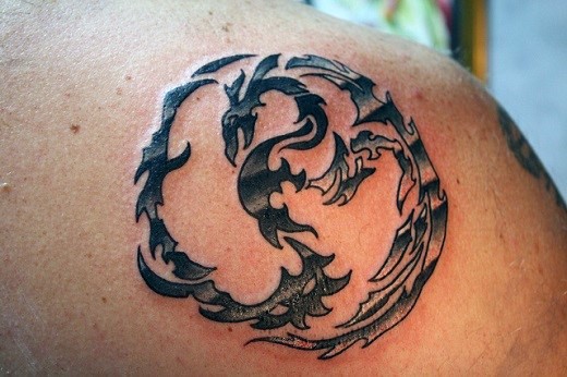 Small black ink shoulder tattoo of fantasy dragon