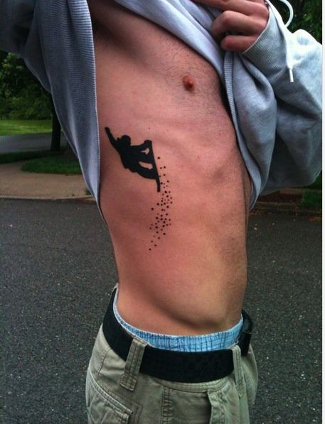 Small blackwork style side tattoo of snowboarder