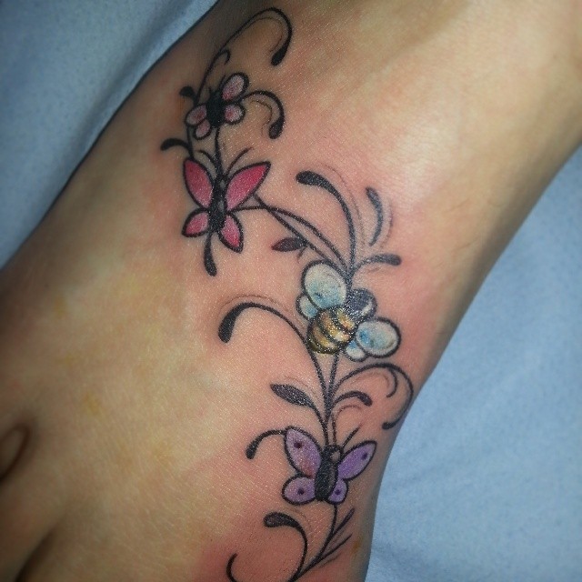 Small butterflies bee and flowers tattoo on foot
