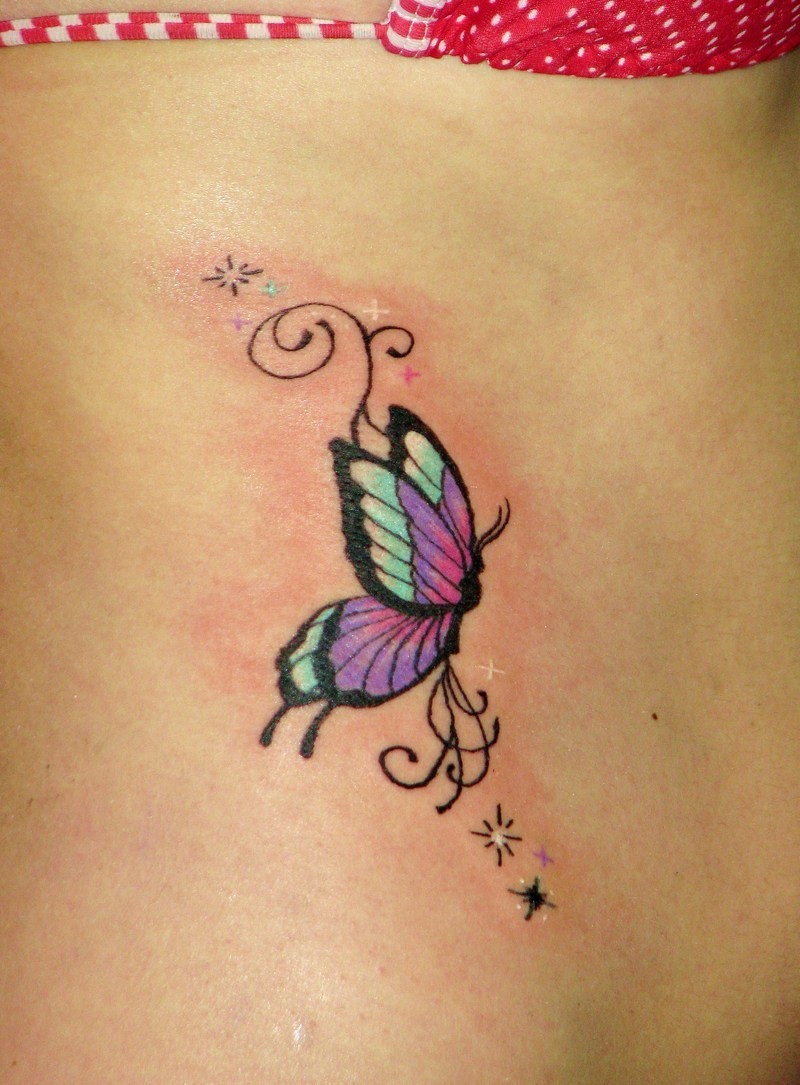 Small butterfly tattoo with stars on ribs