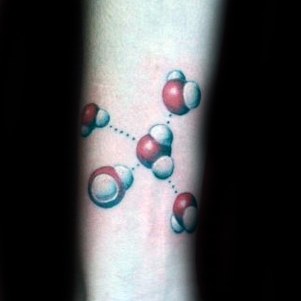 Small cartoon style atoms tattoo on arm