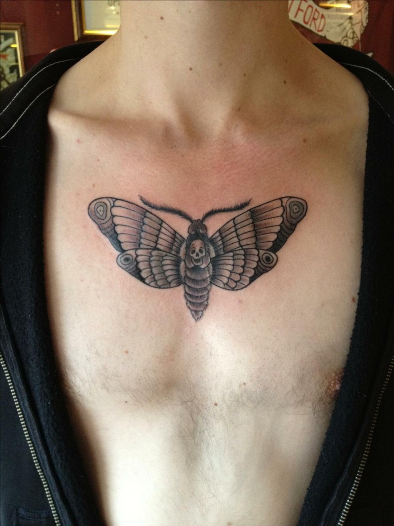 Small cartoon style chest tattoo of little butterfly