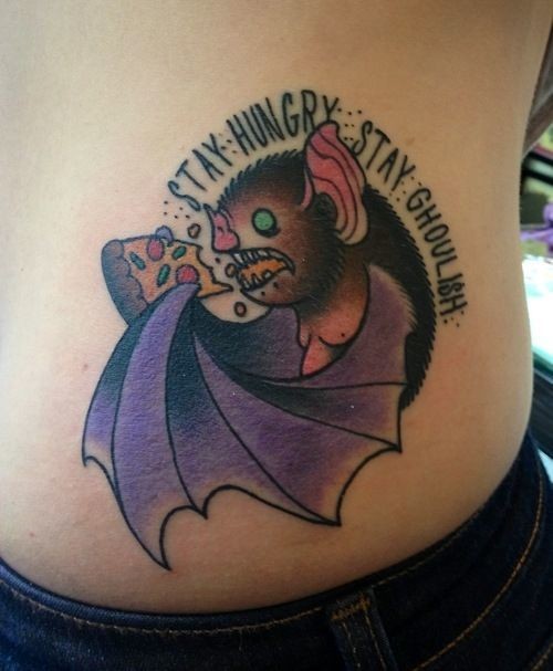 Small cartoon style side tattoo of bat with pizza and lettering