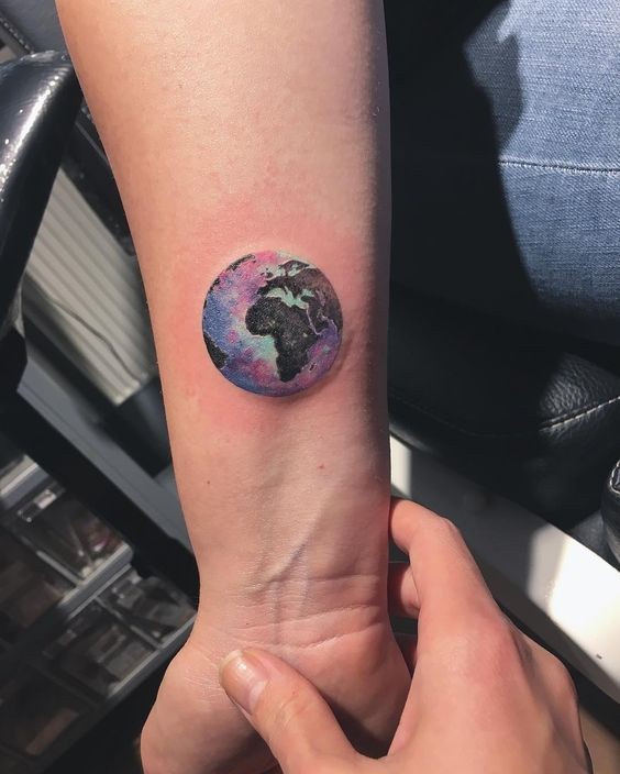 Small circle shaped wrist tattoo Earth planet