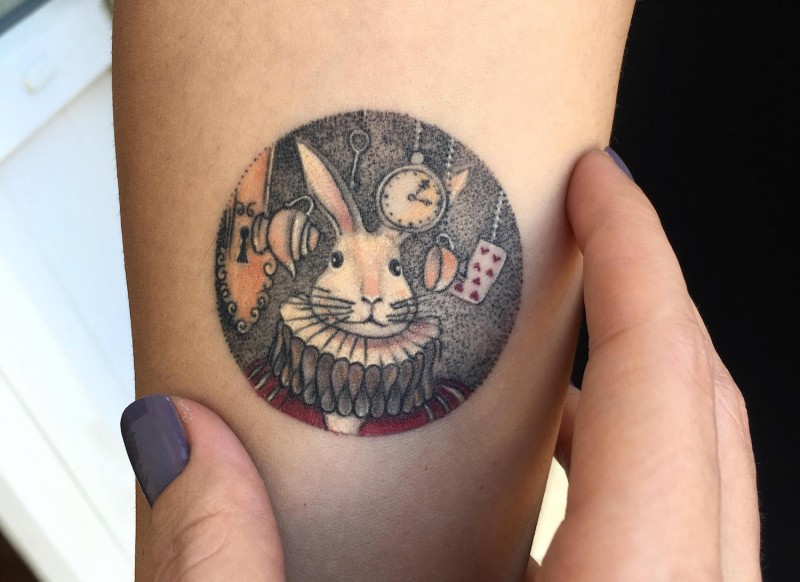 Small colored arm tattoo of Funny bunny with card