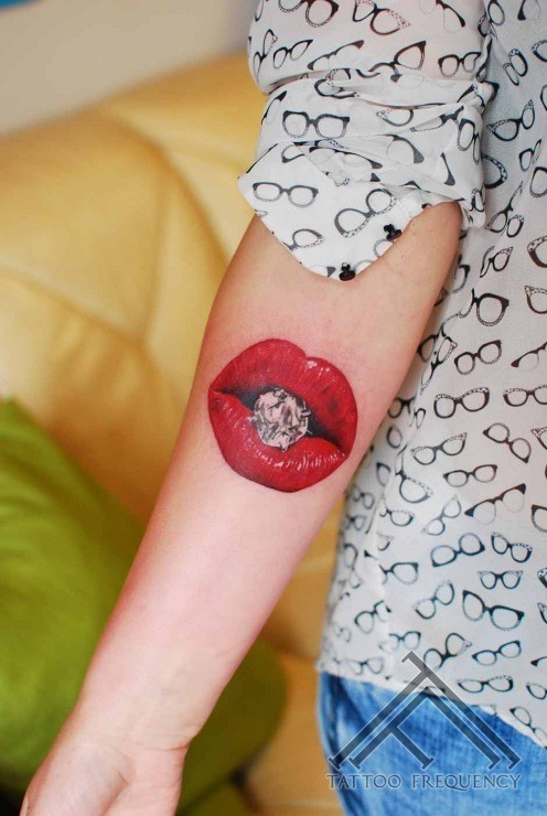 Small colored arm tattoo of red lips with diamonds