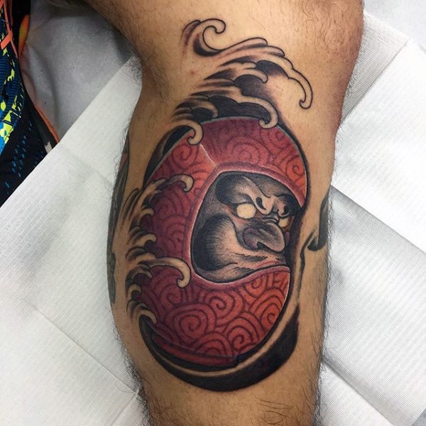 Small colored leg tattoo of daruma doll with waves