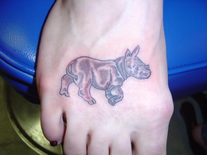 Small cute rhino tattoo on foot