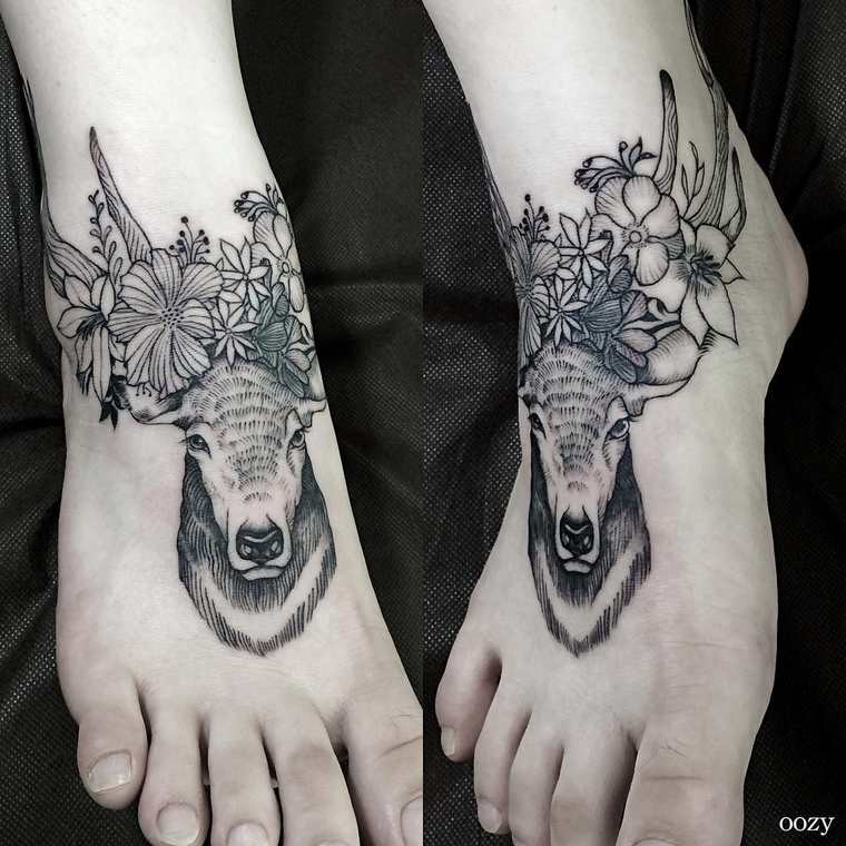 Small engraving style black ink deer tattoo on foot stylized with flowers