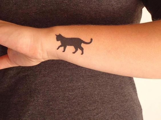 Small for girls style black ink wrist tattoo of cat