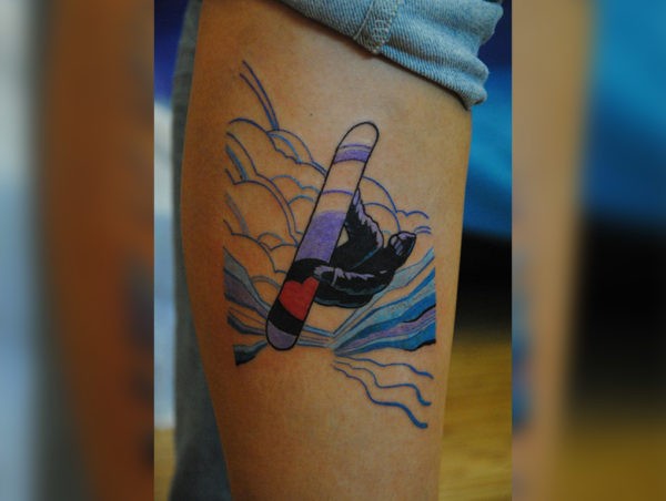 Small illustrative style leg tattoo of snowboarder