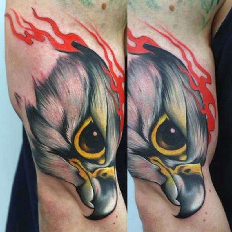 Small natural colored biceps tattoo of eagle head with flames