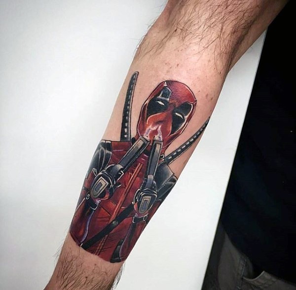 Small nice looking arm tattoo of Deadpool with pistols