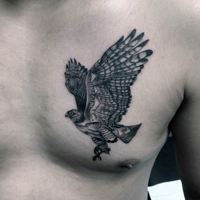 Small nice looking black ink chest tattoo of flying eagle