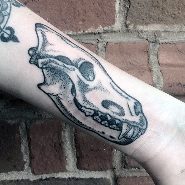 Small old school style forearm tattoo of animal skull