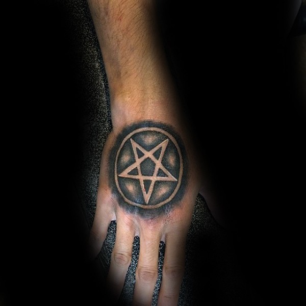 Small stippling style black ink hand tattoo of creepy star in circle
