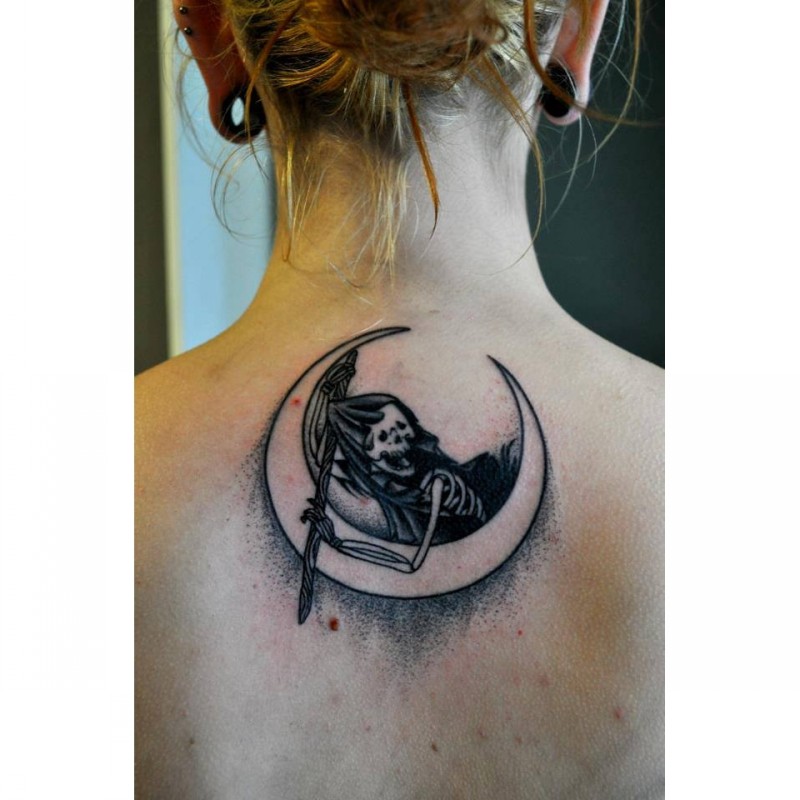 Small stippling style black ink upper back tattoo of skeleton with moon