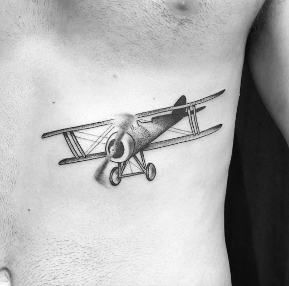 Small stippling style black vintage plane tattoo