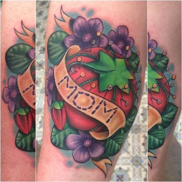 Small sweet looking colored tattoo of big tomato with lettering