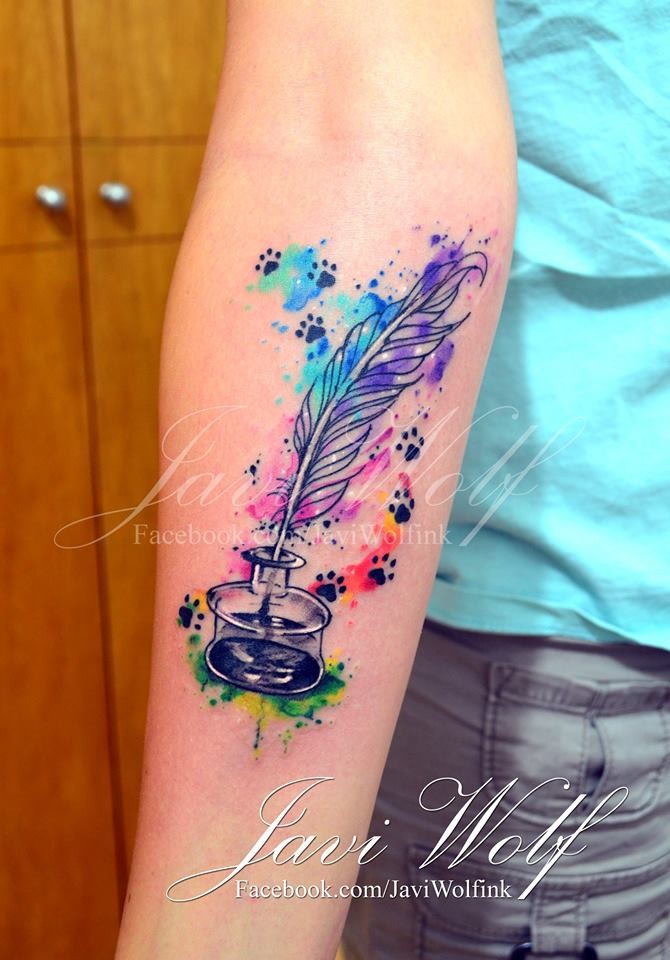 Small watercolor style little ink pot with feather and cat paw prints tattoo on forearm