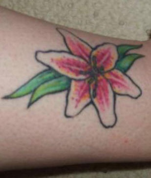 piccolo giglio bianco e rosa sulla gamba tatuaggio