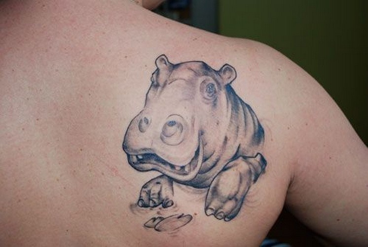 Smiling gray-ink hippo head tattoo on upper back