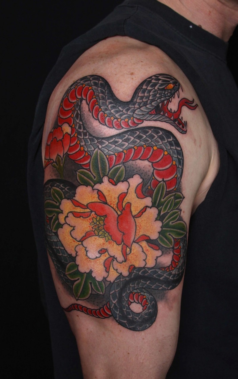Snake and big flower tattoo in colour on arm