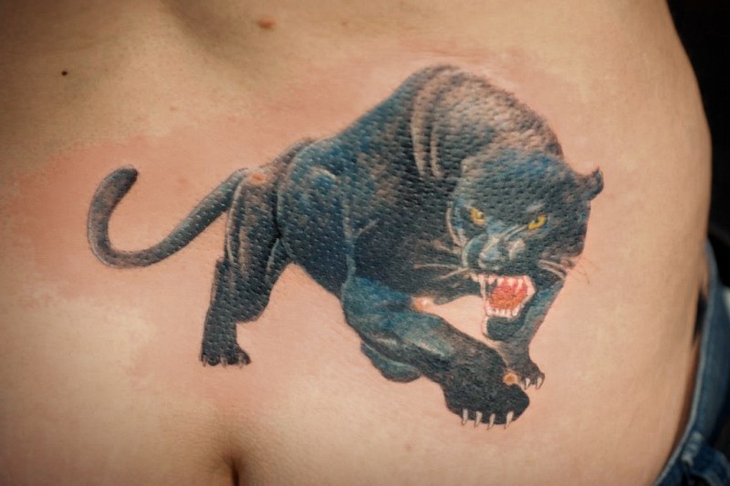 Snarling black panther  with yellow eyes tattoo