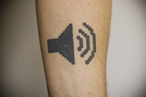 Sound symbol geek tattoo on arm