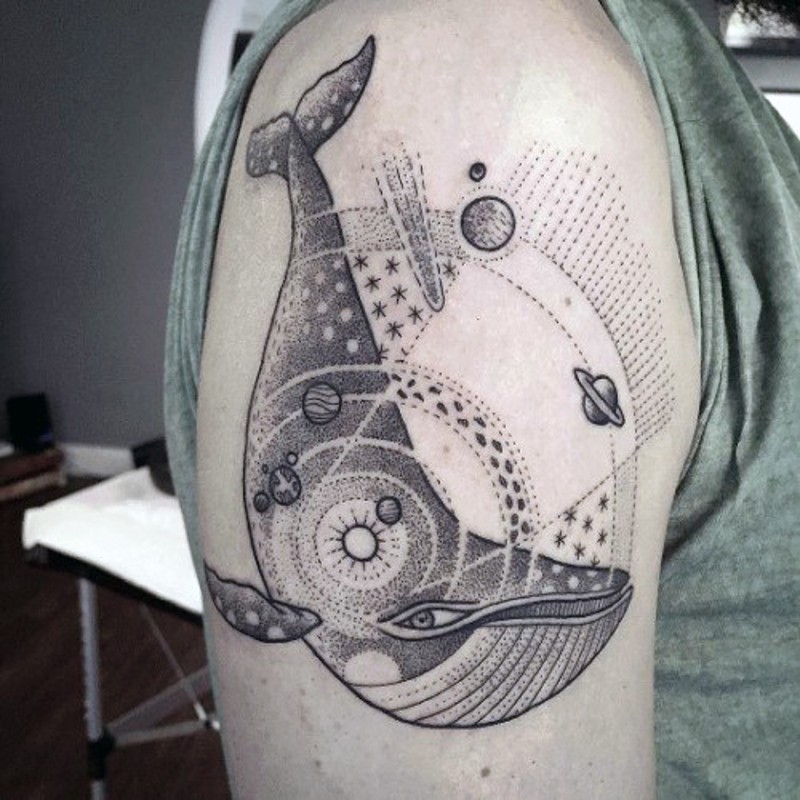 Space themed black and white solar system with wale tattoo on upper arm