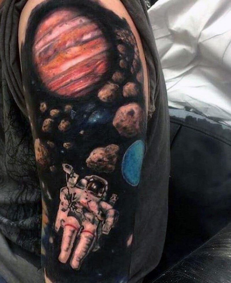 Space themed colored space man shoulder tattoo with planets