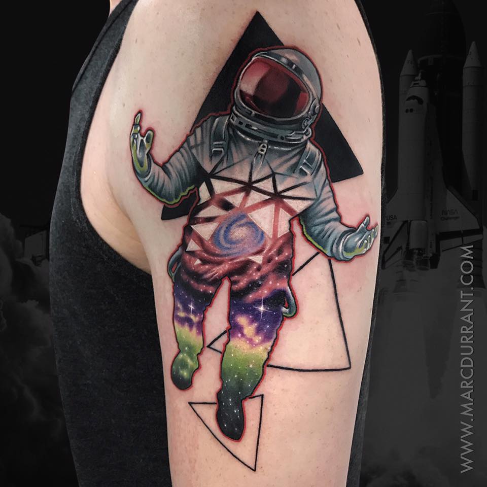 Spaceman tattoo on shoulder