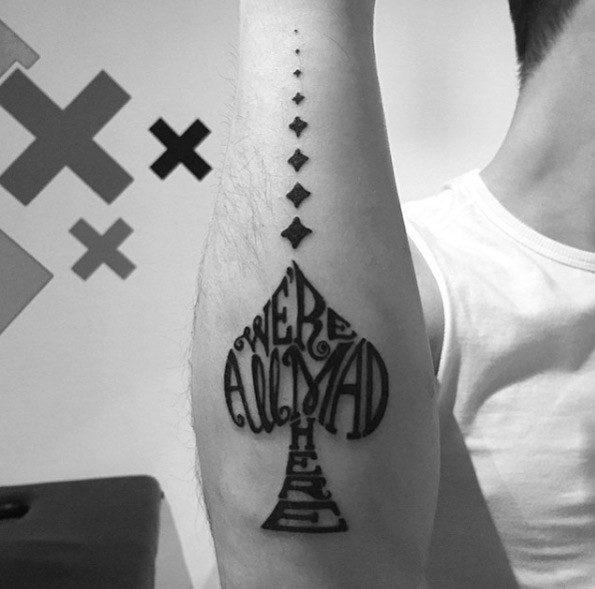 Spades shaped lettering black ink tattoo on forearm with diamond symbols