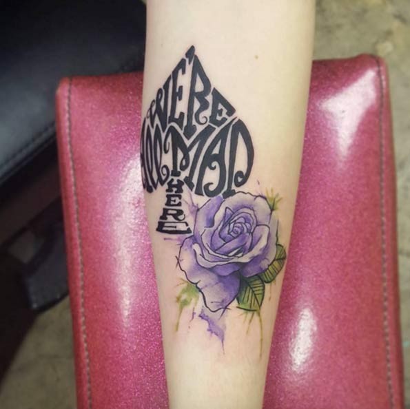 Spades symbol shaped lettering and violet rose flower in watercolor style forearm tattoo