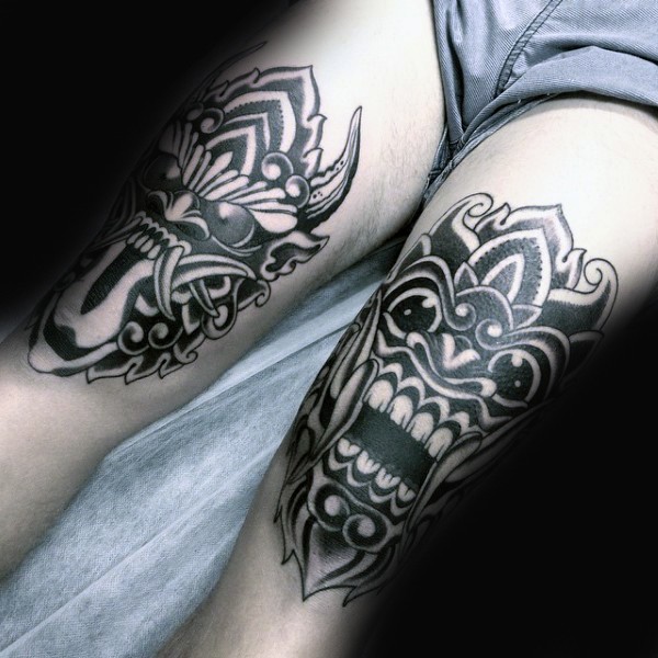 Spectacular black and white antic masks tattoo on thigh