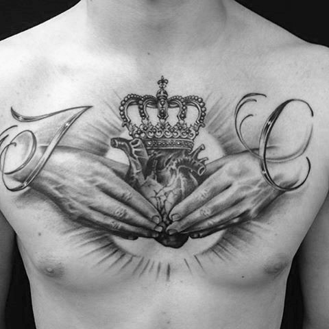 Spectacular black and white chest tattoo of hands holding heart and crown
