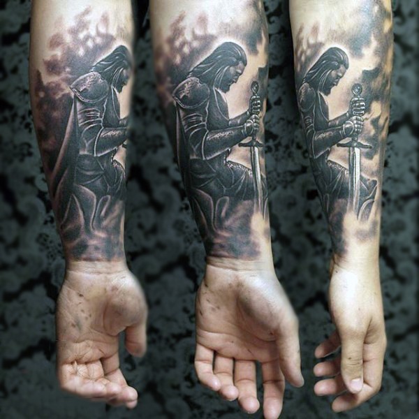 Spectacular black and white forearm tattoo of praying medieval knight