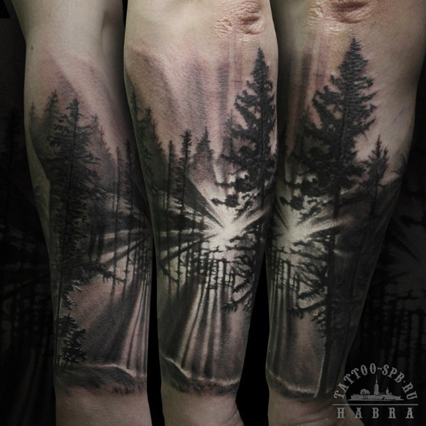 Spectacular black and white forest sunrise tattoo on forearm