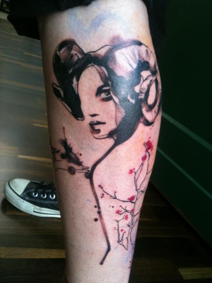 Spectacular black and white leg tattoo of demonic woman