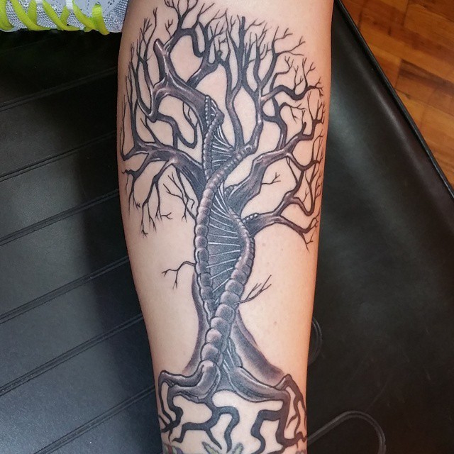 Spectacular black ink DNA shaped tree tattoo on leg