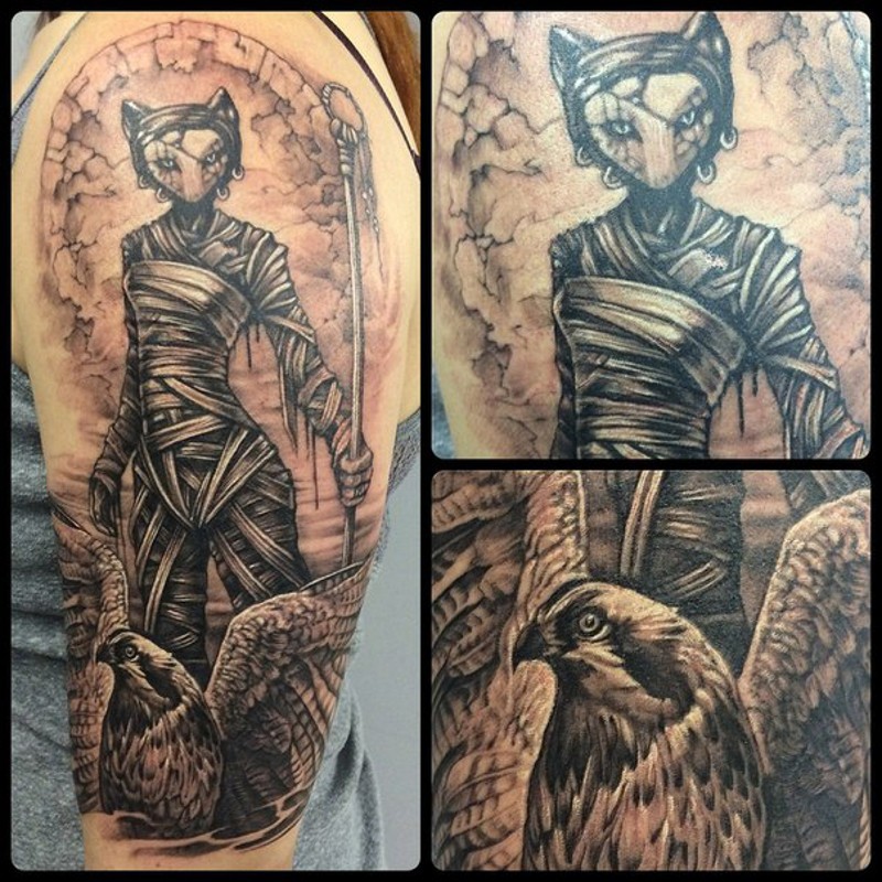 Spectacular black ink mysterious cat shaped witch tattoo on shoulder with eagle