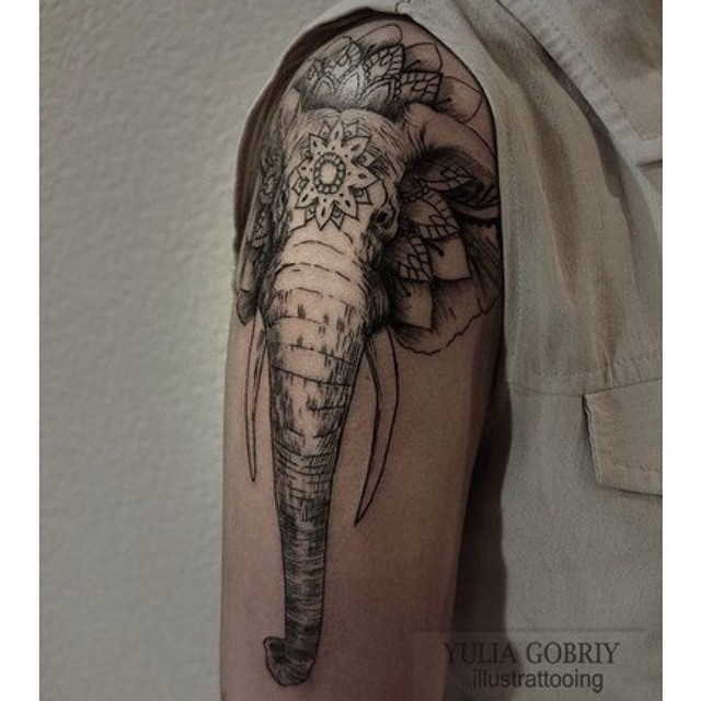 Spectacular black ink shoulder tattoo of mystical elephant head