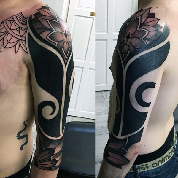 Spectacular blackwork style sleeve tattoo stylized with flowers