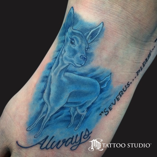 Spectacular blue colored deer tattoo on foot with lettering