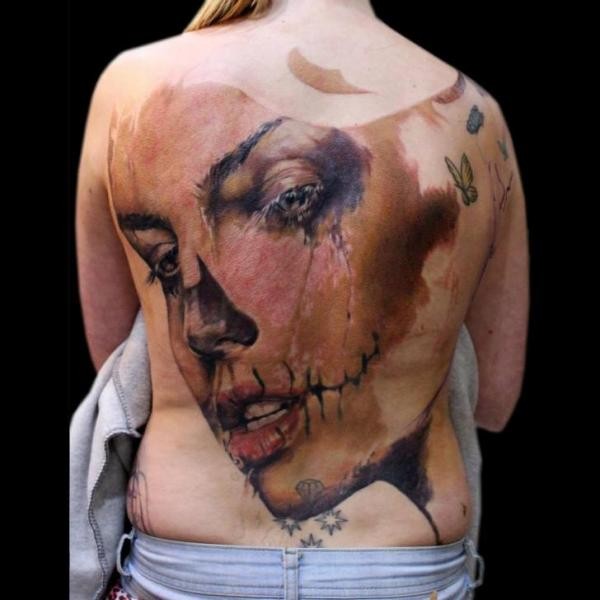 Spectacular creepy looking large whole back tattoo of crying woman face