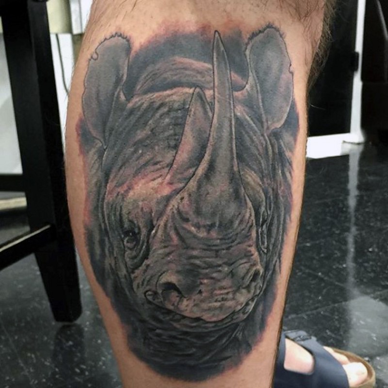 Spectacular detailed colored rhino head tattoo on leg muscle