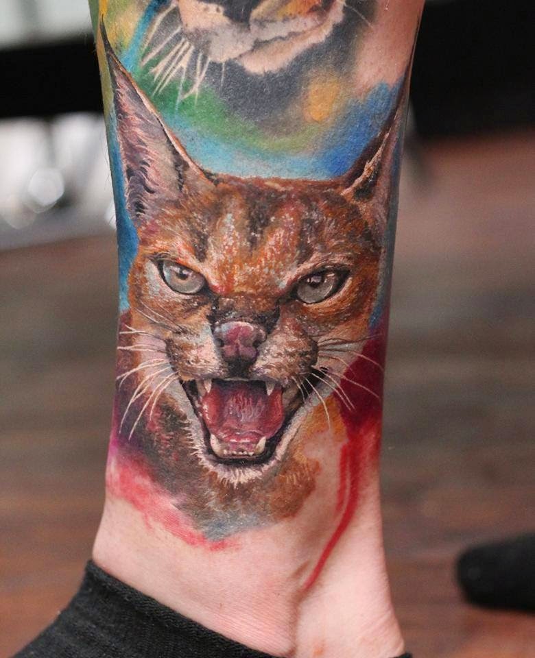 Spectacular lifelike colored ankle tattoo of angry caracal