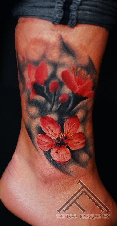Spectacular looking colored ankletattoo of beautiful flower