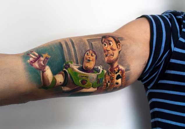 Spectacular looking colored biceps tattoo of Toy Story cartoon heroes